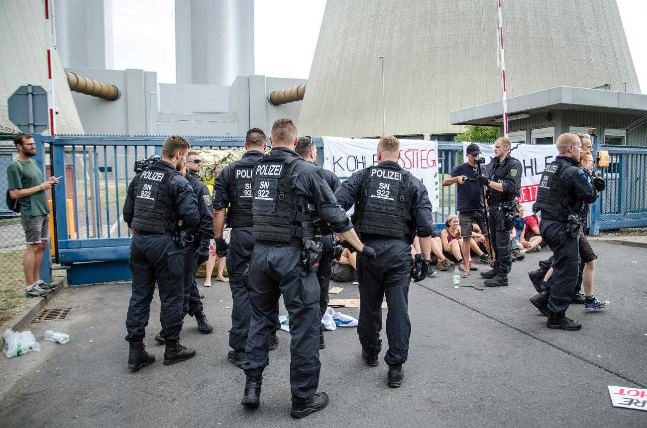 A large group of police officers prepare to remove activists blockading a coal mine in Germany