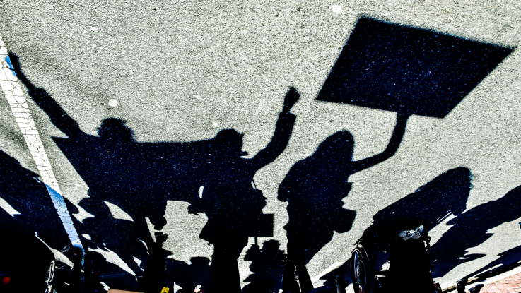 Silhouettes of people marching