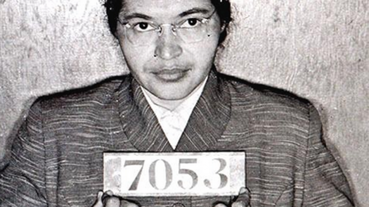A photo of Rosa Parks holding her arrest number