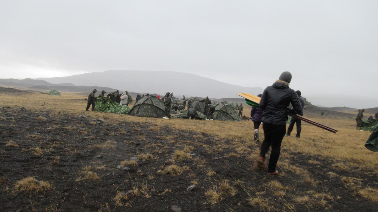 Members of CAM go to speak to NATO soldiers putting up tents during Trident Juncture