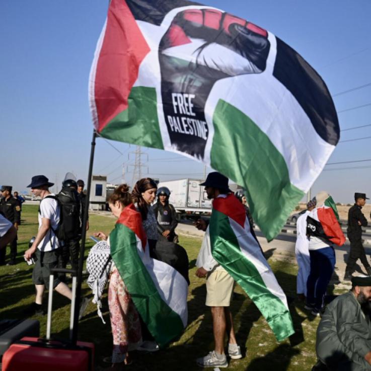 People in a march holding Palestine flags